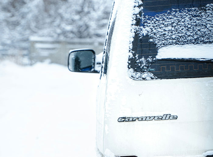 White Caravelle car covered in snow on a cold winter day, illustrating times people got truly lucky outdoors.