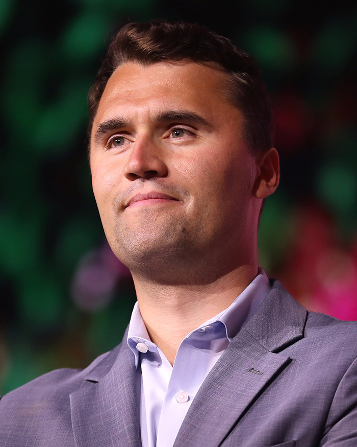 Man in a gray suit and white shirt looking ahead during a public event related to biologist&rsquo;s life lawsuit and national debate.