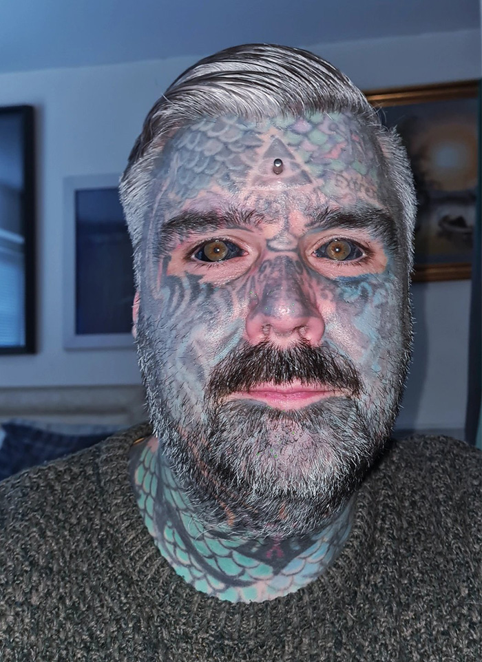 Man with extensive face tattoos and tattooed eyeballs revealing the dangerous process of eyeball tattooing. Man with extensive face tattoos and tattooed eyeballs revealing the dangerous process of eyeball tattooing.