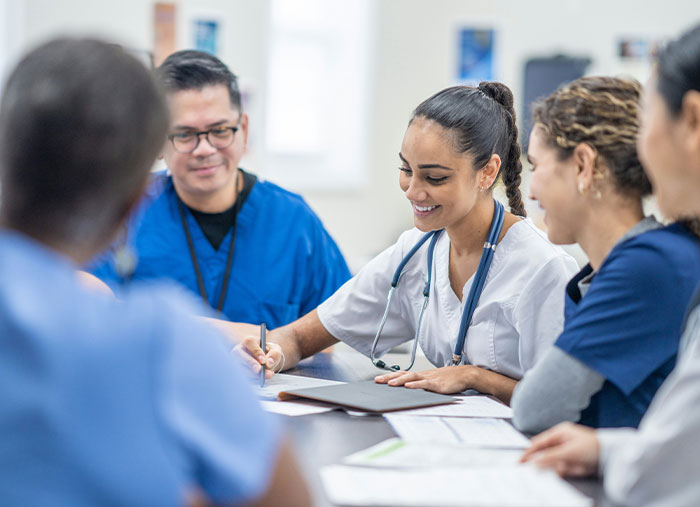 Medical team sharing unexpected stories of how a bad day turned into a life-changing one during a meeting.