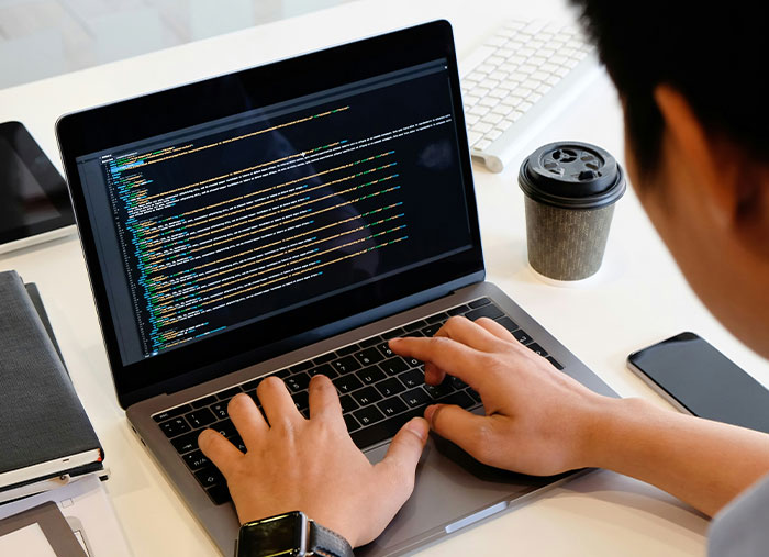 Person coding on a laptop, illustrating unexpected stories of how a bad day turned into a life-changing one.