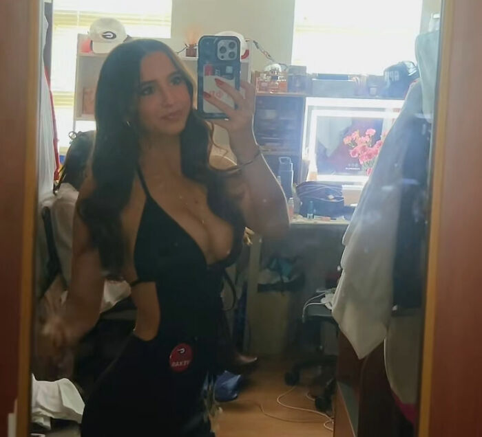 Young stunning woman taking a mirror selfie, identified after going viral at Georgia-Texas game, sparking reactions
