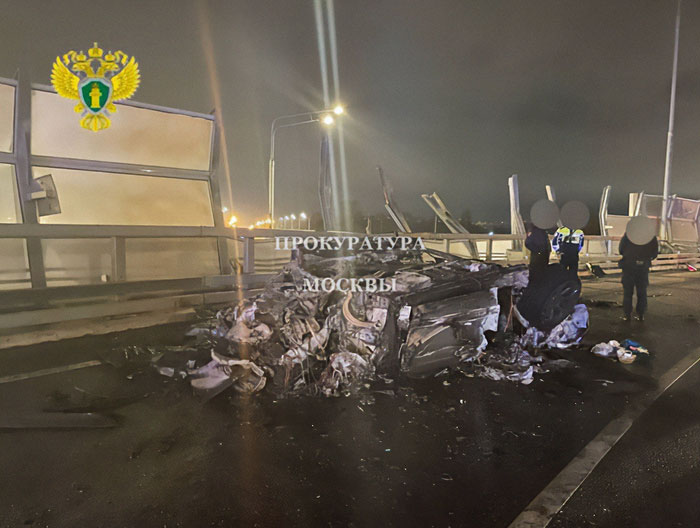 Wreckage of a crashed vehicle with investigators at night, related to crypto scammer behind $500M scheme.