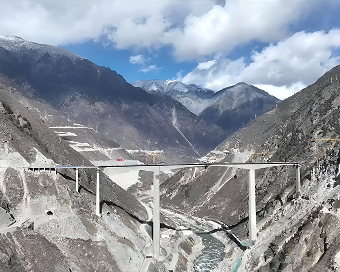 Damaged ambitious bridge in China collapsing into dust months after opening in a mountainous landscape under a partly cloudy sky. Damaged ambitious bridge in China collapsing into dust months after opening in a mountainous landscape under a partly cloudy sky.