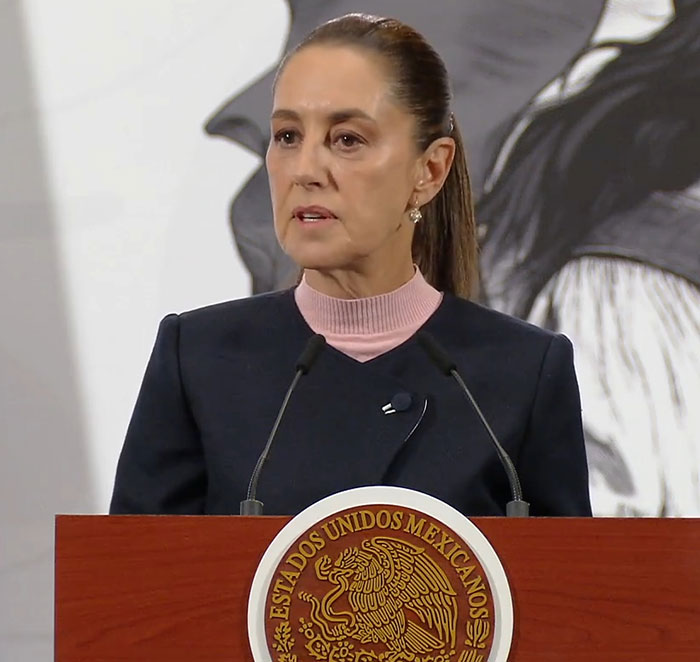 Female Mexican president speaking at podium with seal, highlighting reality for a lot of women in leadership roles