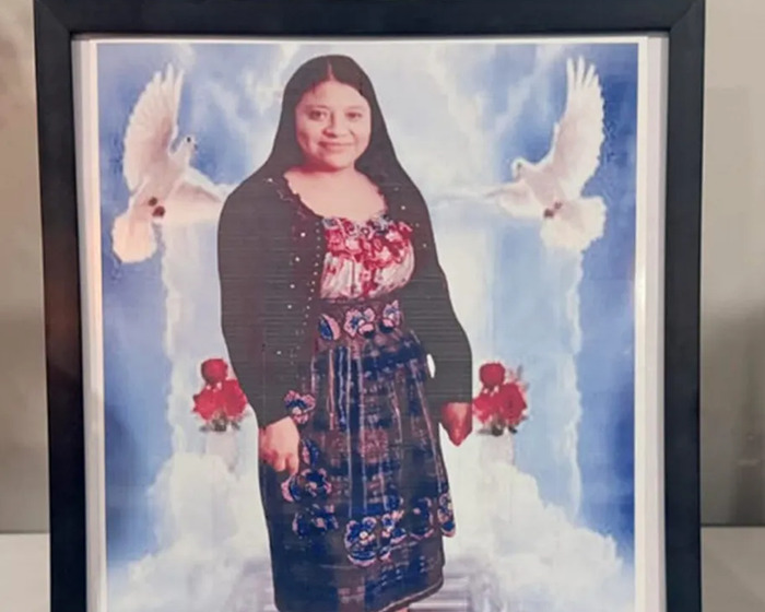 Framed photo of a cleaning lady with doves and roses in a memorial-style background, symbolizing loss and remembrance.
