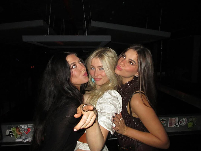 Three young women posing together at a night event, with Claudia Schiffer&rsquo;s lookalike daughter in a racy outfit.