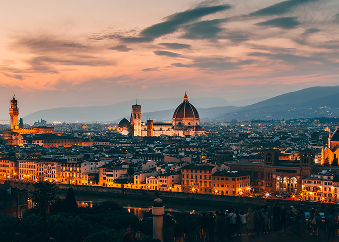 Sunset view of European cityscape with historic buildings, highlighting the debate on whether life is better in the USA or Europe.