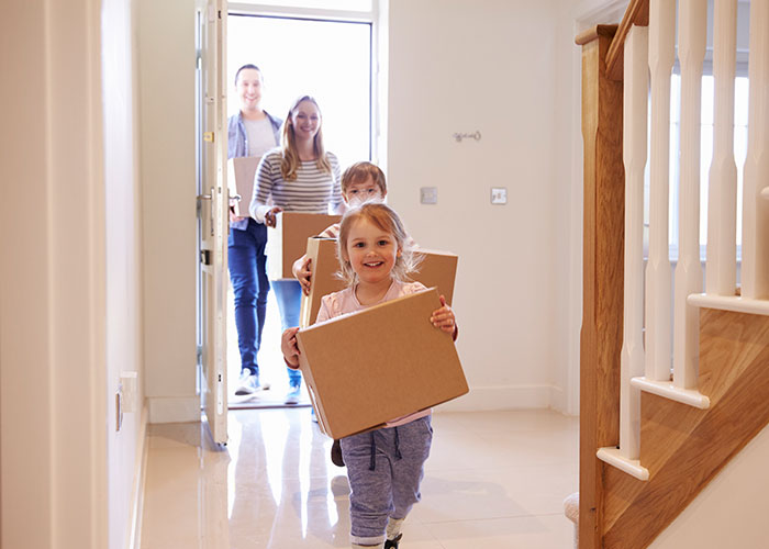 Family moving into a new home, highlighting life and lifestyle comparisons between the USA and Europe for SEO.