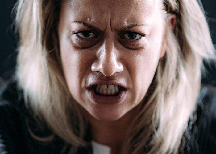 Close-up of an angry woman showing frustration, illustrating intense emotions in weird and crazy ER stories context.