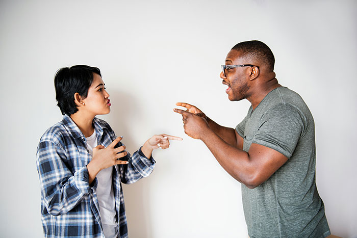 Grieving dad and sister-in-law arguing intensely about birthday expenses for daughter in a tense, emotional moment.