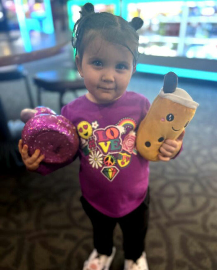 Toddler girl holding toys indoors with focus on young child relating to man leaving 2YO daughter in burning car incident. Toddler girl holding toys indoors with focus on young child relating to man leaving 2YO daughter in burning car incident.