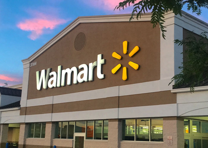 Walmart store exterior at sunset, illustrating companies competing for the corporate Darwin award for business failures.