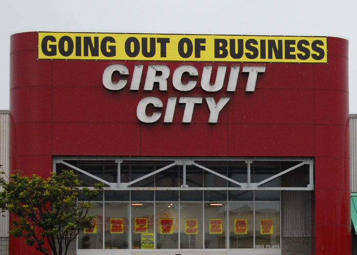 Circuit City store with going out of business sign, illustrating corporate Darwin award for dumb business failures.