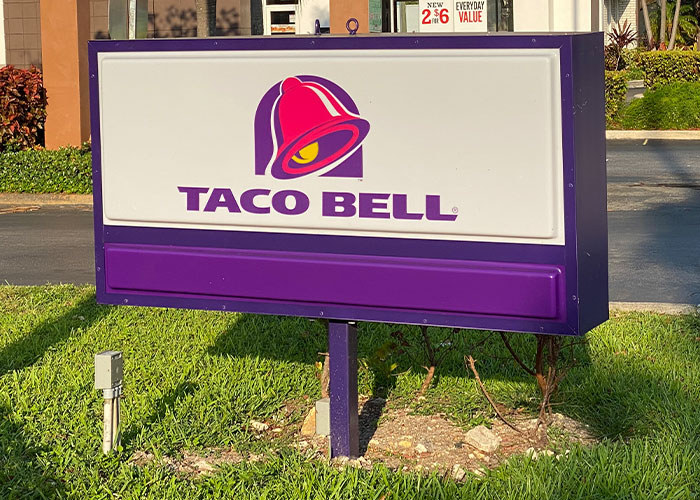 Taco Bell sign outside a restaurant, illustrating one of the companies in the corporate Darwin award competition.