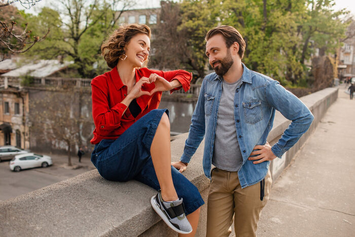 A smiling couple sharing a moment outdoors, illustrating dating older people stories with a single happy connection.