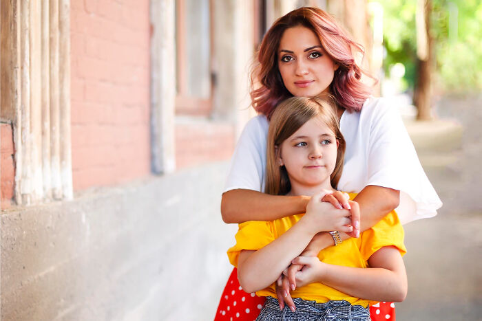 Woman and girl embracing outdoors, reflecting warmth and connection in stories about dating older people.