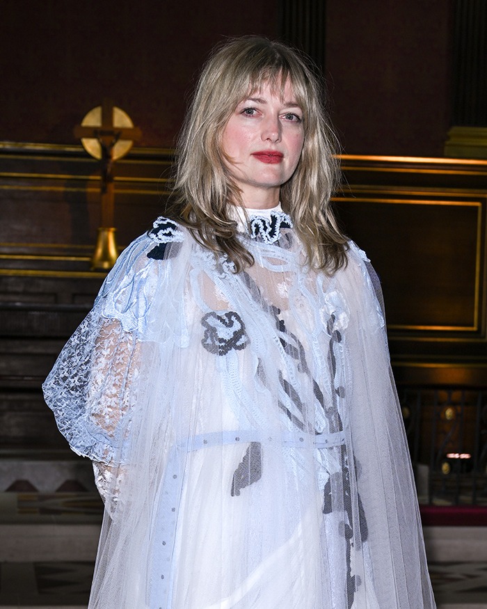 Alison Sudol wearing a sheer white dress with lace details, posing indoors amid David Harbour backlash news.