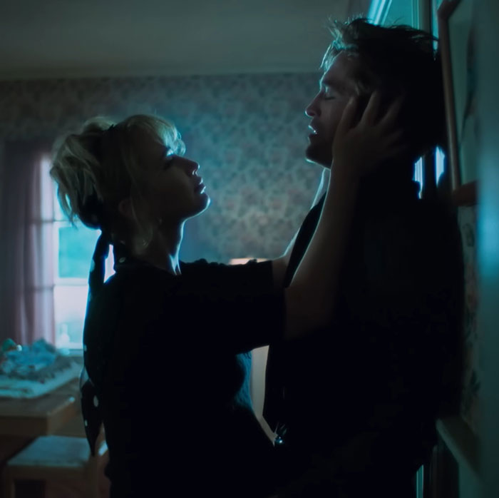 Jennifer Lawrence and Robert Pattinson in an intimate moment indoors, highlighting their viral photos and recent confession.