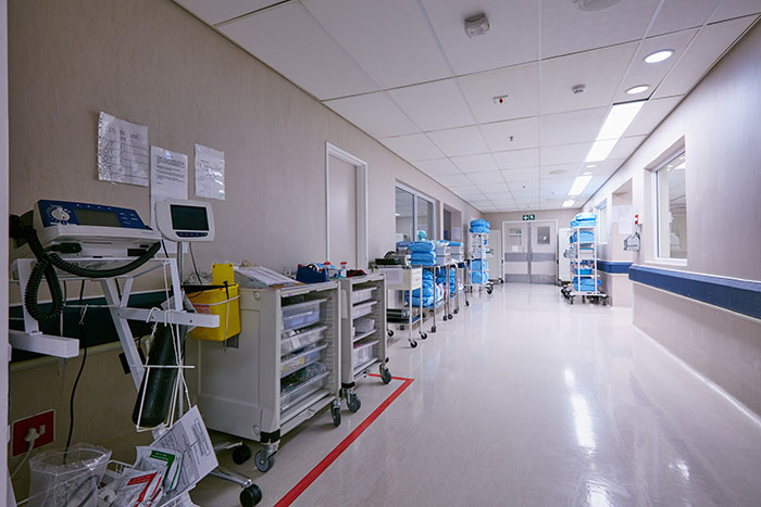 Hospital corridor with medical equipment and supplies, illustrating a setting related to surgeons and doctors' experiences.