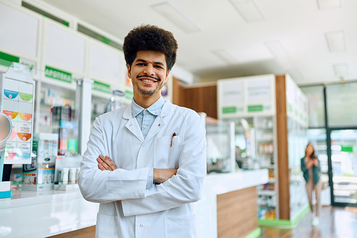Young surgeon in white coat standing confidently in a medical facility, representing doctors recalling their worst mistakes.
