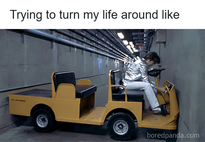 Person in silver jacket sitting in a small yellow cart stuck against a wall, illustrating random memes about unique experiences.