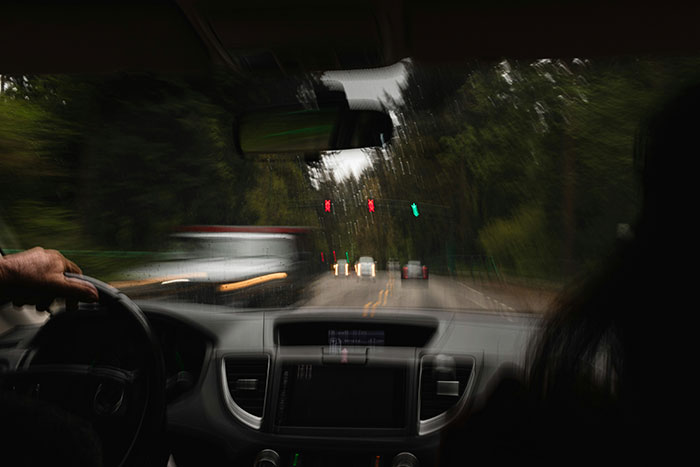View from inside a car at night with blurred traffic lights, illustrating a viral rear-ending incident involving a police officer.