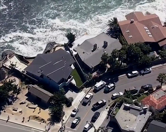 Aerial view of coastal homes and parked cars, related to ex-employees who kidnapped toxic tech CEO story.
