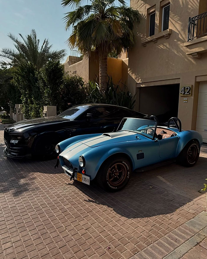 Luxury cars parked outside a Dubai villa linked to the crypto scammer behind a $500M scheme.