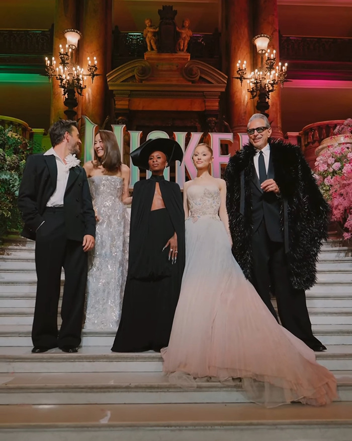 Michelle Yeoh with cast members posing on stairs in elegant outfits highlighting an extremely thin and worrying appearance. Michelle Yeoh with cast members posing on stairs in elegant outfits highlighting an extremely thin and worrying appearance.