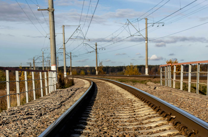 Railway tracks curving through a rural landscape, symbolizing unexpected journeys and lives that ended in surprising ways.
