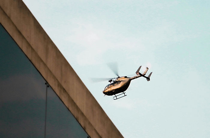 Helicopter flying near building at dusk, illustrating unexpected incidents in stories of lives that ended unexpectedly.