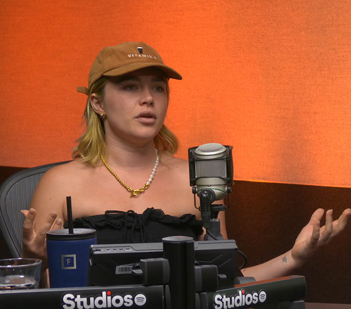 Florence Pugh speaking in a podcast studio, discussing age gap and experiences with ex Zach Braff.