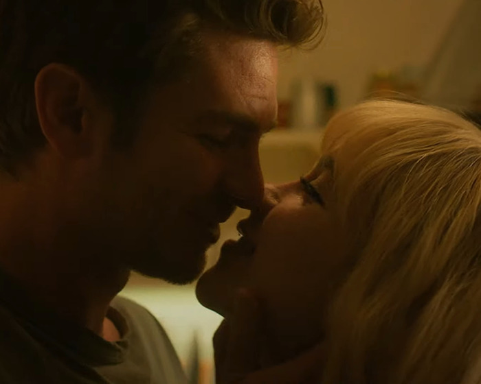 Florence Pugh and co-star in a close, intimate scene on set highlighting steamy moments during filming.