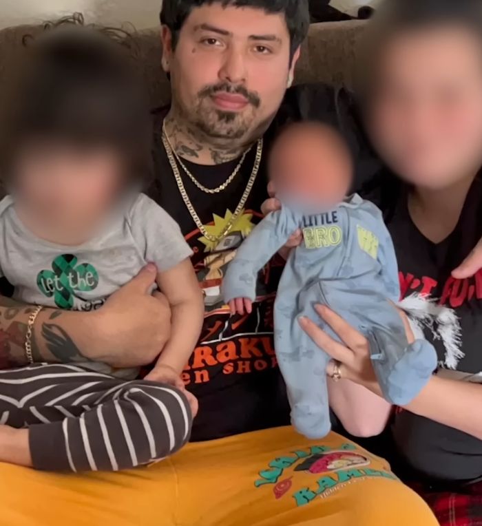 Man holding children indoors with woman, related to woman found chained in backyard in bizarre case story.