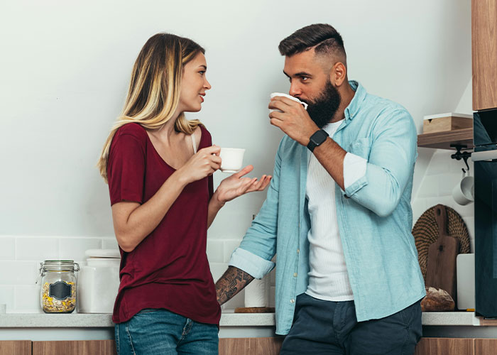 Two people having a serious conversation over coffee, reflecting tension from friendship crumbling after secret exposed. Two people having a serious conversation over coffee, reflecting tension from friendship crumbling after secret exposed.