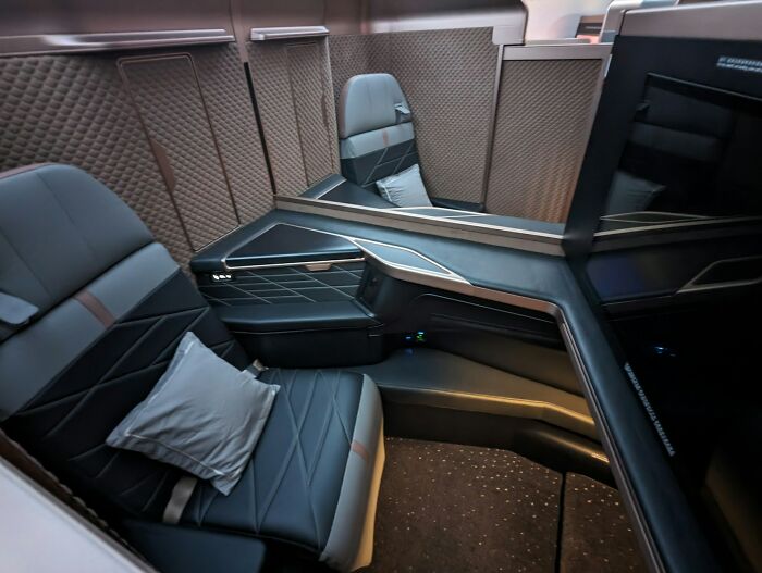 Luxury private jet cabin with leather seating and modern design, illustrating comfort in travel and relaxation.
