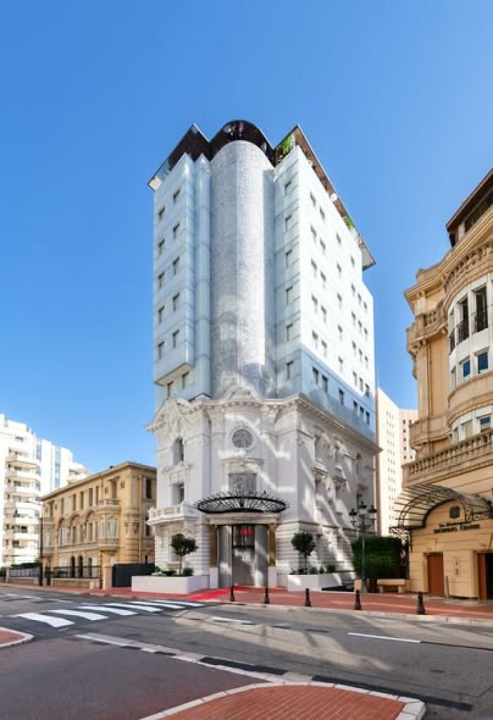 Tall urban building with contrasting modern and classical architecture, illustrating ugly and unesthetic modern architecture styles.