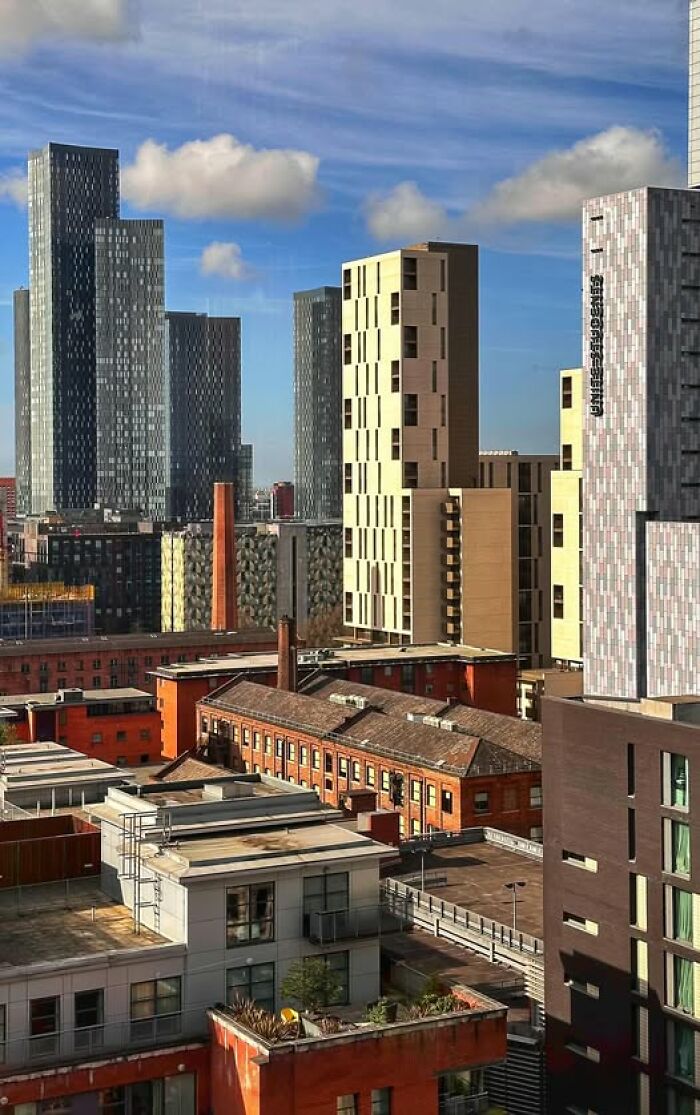Ugly and unesthetic modern architecture buildings in an urban cityscape under blue sky with scattered clouds.