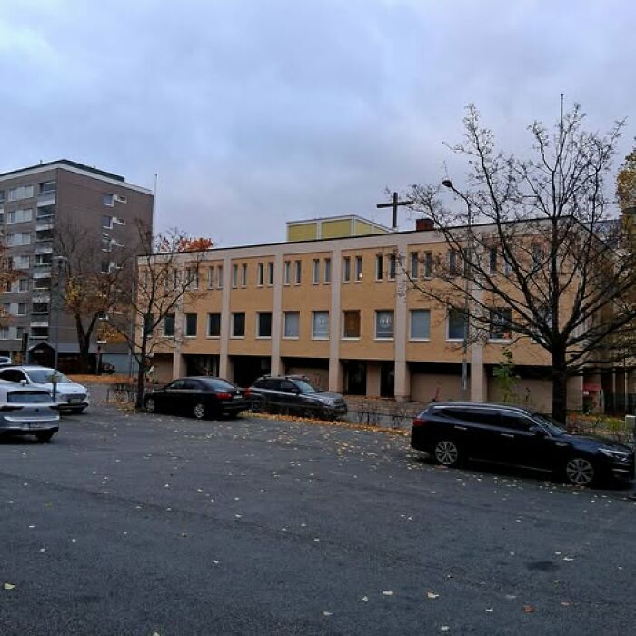 Blocky ugly building with muted colors and bare trees, illustrating unesthetic and depressing modern architecture.