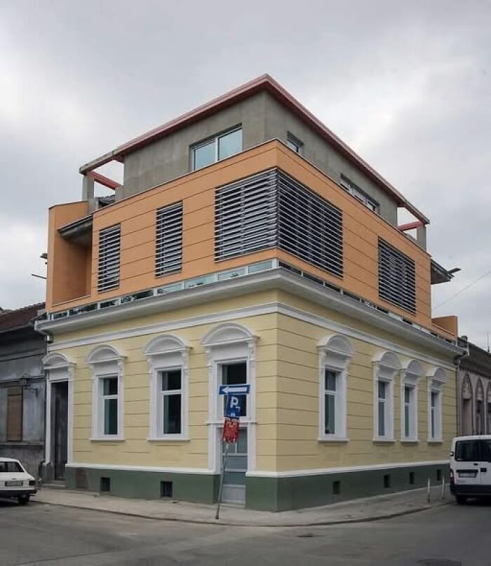 Modern architecture with an unesthetic and ugly building design featuring mismatched styles on a street corner.