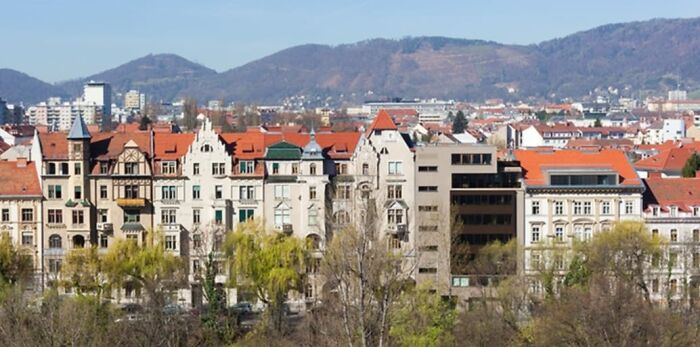 Row of old European buildings with a mix of architectural styles, some appearing unesthetic and detracting from modern architecture.