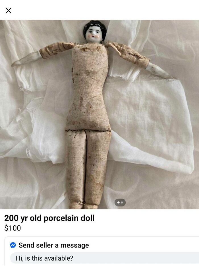 Worn 200 year old porcelain doll with fabric limbs, showcased in a quirky FB Marketplace unhinged post.