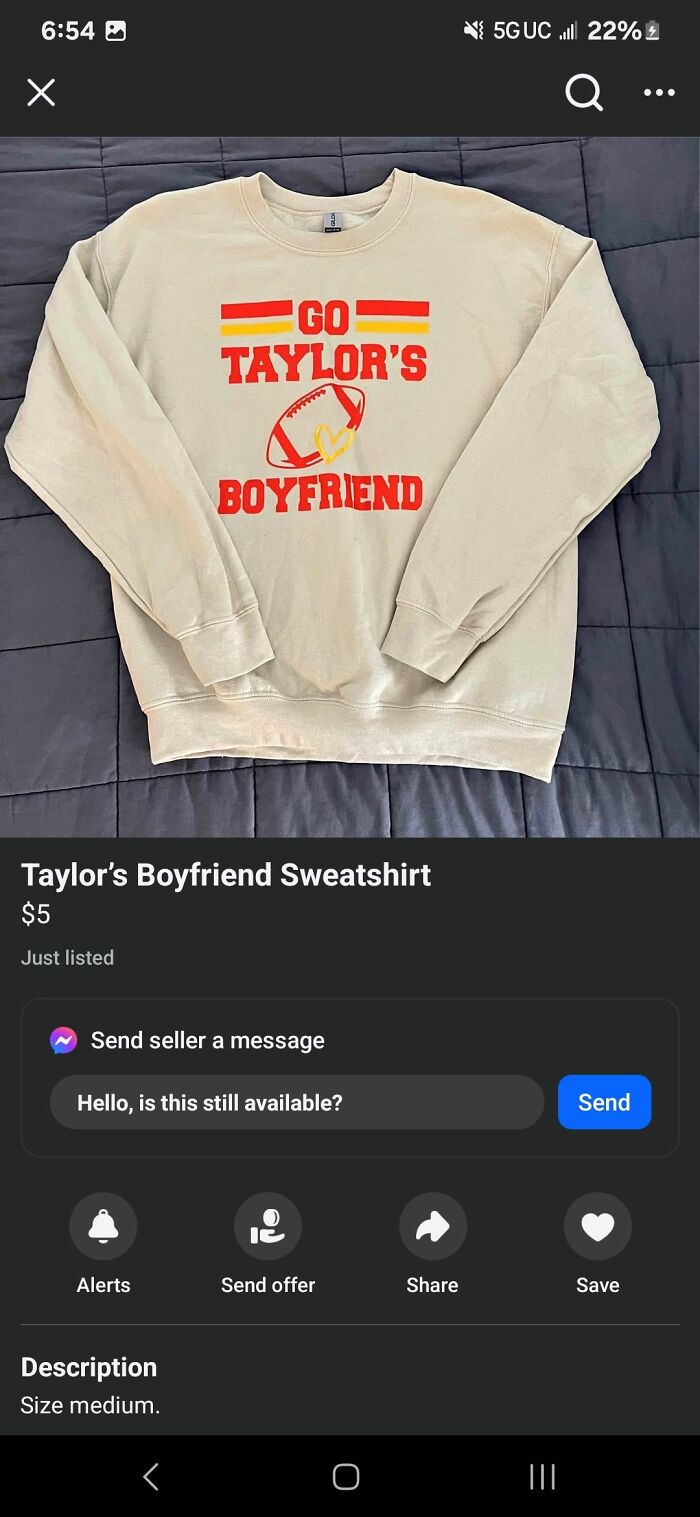 Beige sweatshirt with red and yellow design saying Go Taylor's Boyfriend listed on FB Marketplace.