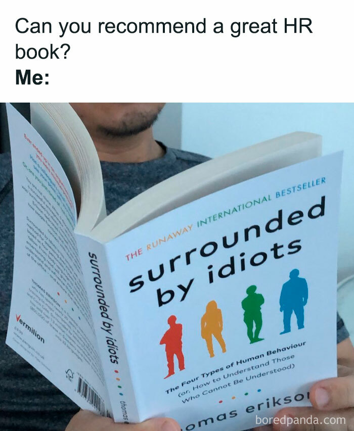 Person reading a humorous HR book titled surrounded by idiots, highlighting the chaos of working in human resources.