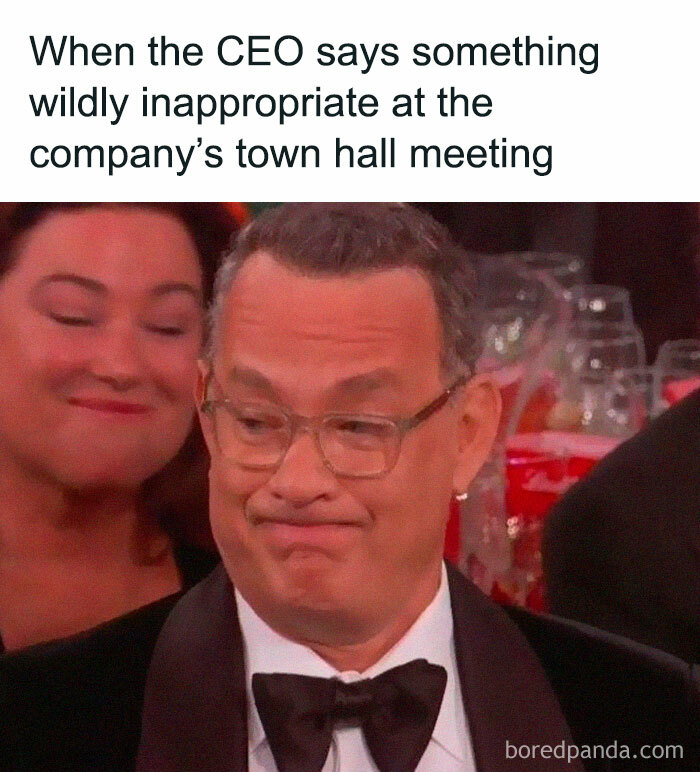 Man with glasses making a skeptical face at a company town hall, capturing chaos of working in human resources.