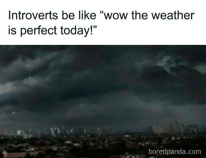 Dark cloudy sky over city with text about introverts and perfect weather, related to laughgorithm memes for a laugh today.