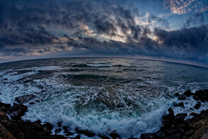 Stormy ocean waves under dark clouds at dusk, illustrating the unpredictability of upcoming online thread events.