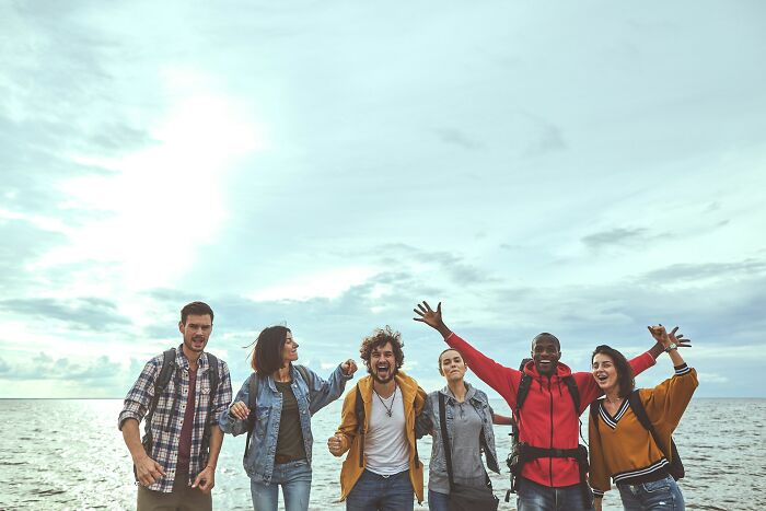 Group of friends at the beach laughing and having fun, capturing moments people wanted to say something funny but hurt loved ones.