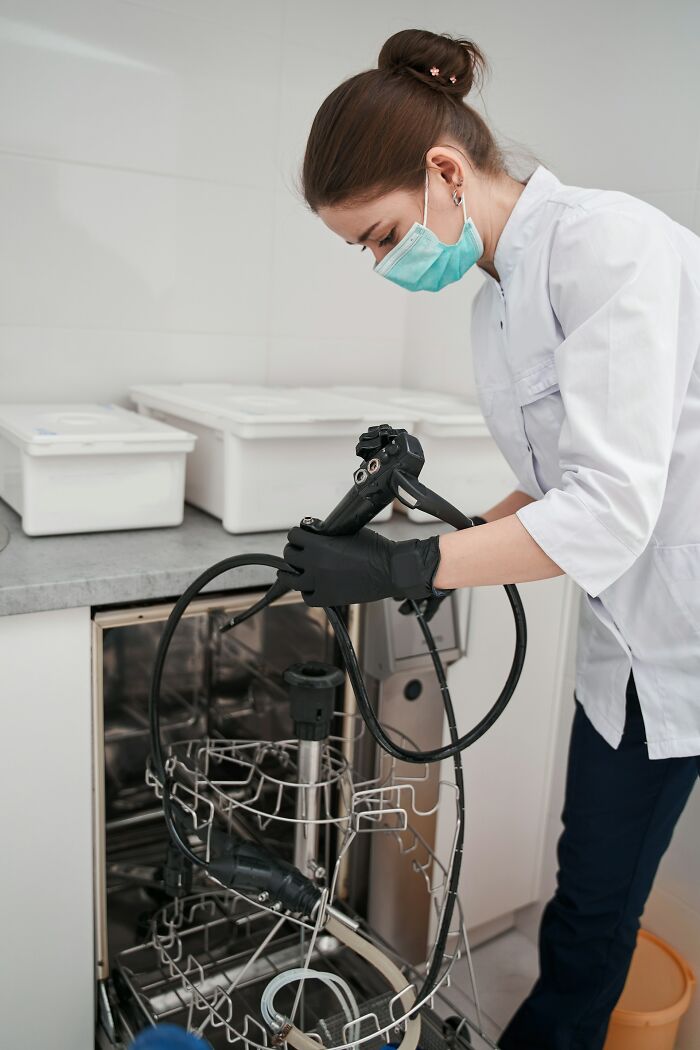 Medical professional cleaning endoscope in clinic highlighting mysterious medical issues and clear diagnoses.